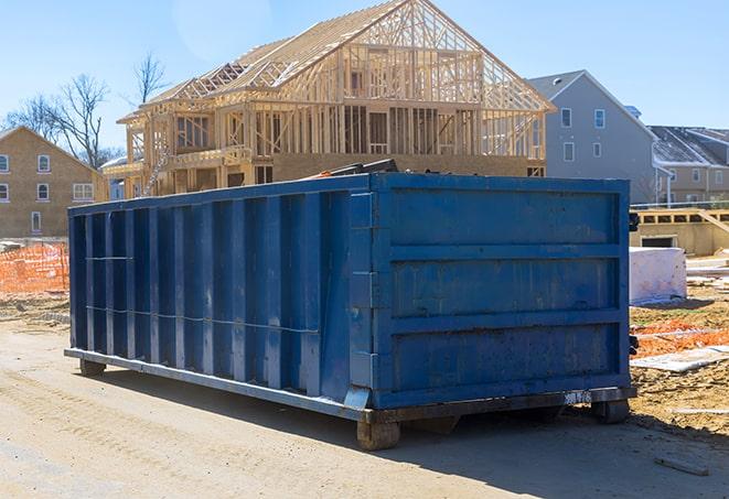 a pile of construction materials inside a residential dumpster